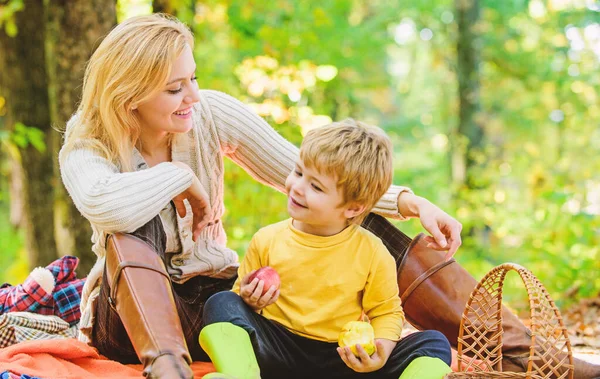 Having snack during hike. Happy childhood. Mom and kid boy relaxing while hiking forest. Family picnic. Mother pretty woman and little son relaxing forest picnic. Good day for spring picnic in nature