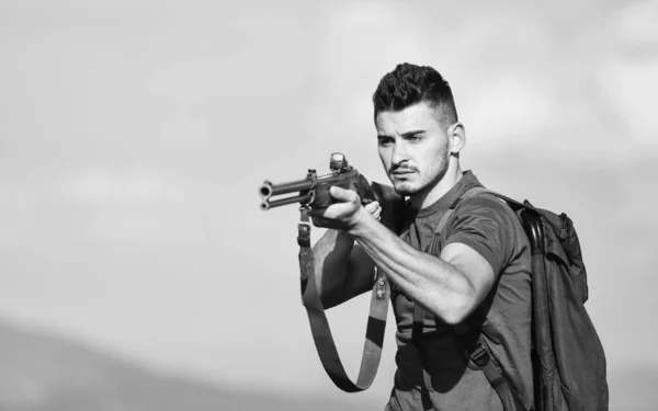 Safety measures. Natural environment. Hunter handsome guy with weapon. Hunter spend leisure hunting. Hunting equipment. Brutal masculine hobby. Man observing nature background. Hunter hold rifle — Stock Photo, Image