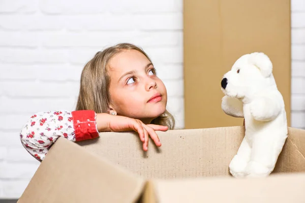 day dreamer. happy little girl with toy. purchase of new habitation. repair of room. new apartment. happy child cardboard box. Cardboard boxes - moving to new house