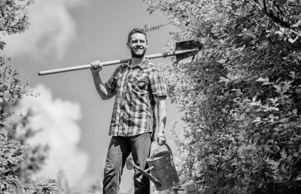It is time to plant prepare beds and care for lawn. Pick out flats favorite plants. Gardening pro tips. Spring gardening. Man bearded hipster hold shovel and watering can. Spring gardening checklist — Stock Photo, Image