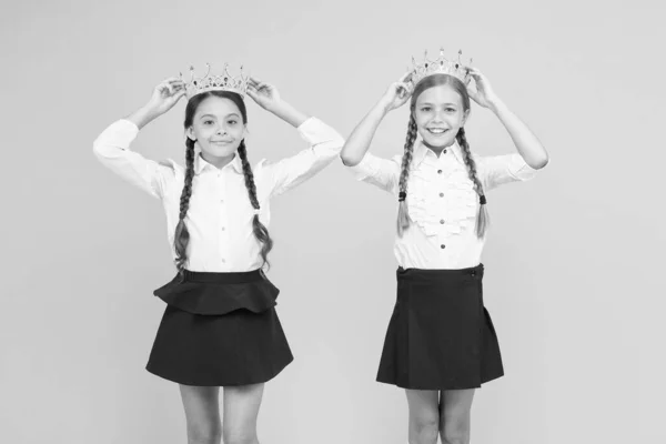 Soñando con fama y riqueza. Las colegialas llevan coronas doradas símbolo de respeto. Premio y respeto. Linda princesa. Premio motivacional para niños en edad escolar. Coronación de premios. Alumnos brillantes — Foto de Stock