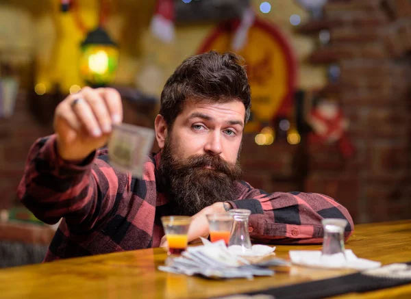 Hipster holds money, cash to buy more alcohol.