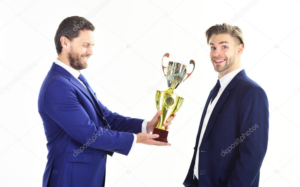 Businessman with cheerful face receives golden prize.