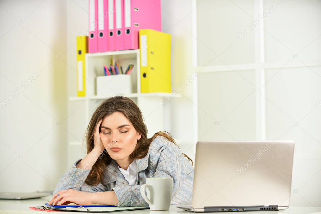 sexy girl in jacket use laptop. tired woman work online on computer. confident office worker. secretary with document folder. formal fashion style. brunette woman with makeup. Concentrated on work