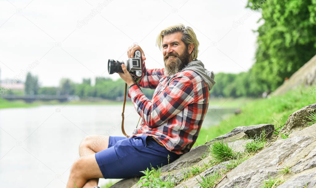 Carefree and happy. photographer use vintage camera. bearded man hipster take photo. photo shooting outdoor. brutal man traveler with retro camera. photography in modern life. travel tips