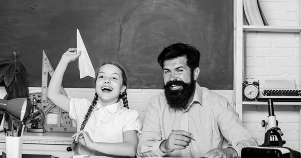 Teacher and schoolgirl. Man bearded pedagogue and pupil having fun. Developing caring learners who are actively growing and achieving. School learners leisure. Creating a community of learners