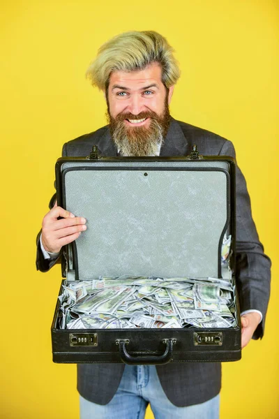 Billionaire. live in luxury. bag with dollar. happy and successful man hold money case. bearded man show office briefcase. good business deal. successful business concept. rich man with beard