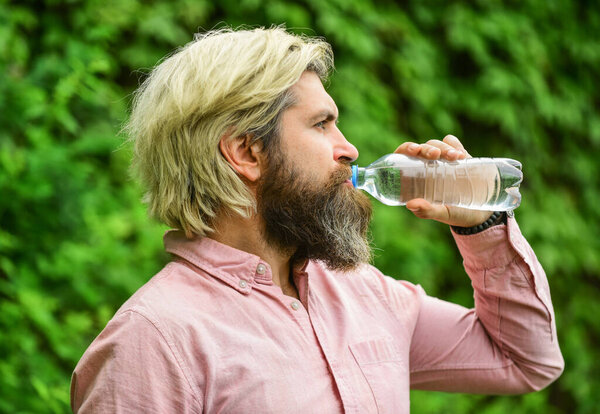 moisturize dry mouth. bearded mature man drinking some water. fresh and healthy water from bottle. healthcare and water balance concept. need to quench thirst. refresh in hot weather