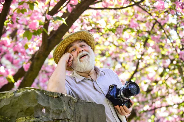 Travel and tourism. Happy grandfather. Spring holidays. Travel photo. Retirement travel. Capturing beauty. Photographer in blooming garden. Senior man hold professional camera. Photography courses — Stock Photo, Image
