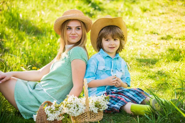 Eco living. Love and respect motherland. Weekend leisure. Explore nature. Mother and son relaxing. Spring holiday. Good vibes. Spring season. Happy holidays. Cowboy family collecting spring flowers