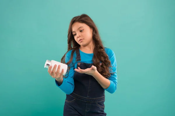 Stärkung der Immunität. Omega-Öle und Säuren. Beste Vitamine. Sichere Behälter. Kleines süßes Kind, das Vitamin nimmt. Lebensmittelzusatzstoffe. Pillen für Kinder. Vitamin- und Mineralstoffkomplex. Medizinkonzept — Stockfoto