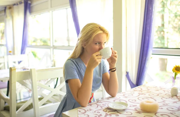 Woman with dreamy face waits for date in provence interior.