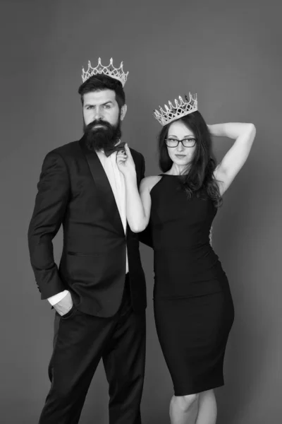 Fame and popularity. Famous couple. Proud of their love. Perfect match. Elite society. Being recognised and proud. Proud couple. Woman and bearded man wear crowns. Selfish egoist. Superiority complex