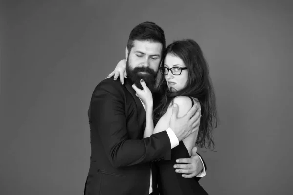 Perfect couple. Couple in love red background. Couple of sensual woman and bearded man. Loving couple hug in formal wear. Wedding anniversary. Holiday celebration. Valentines day. Romance. Love