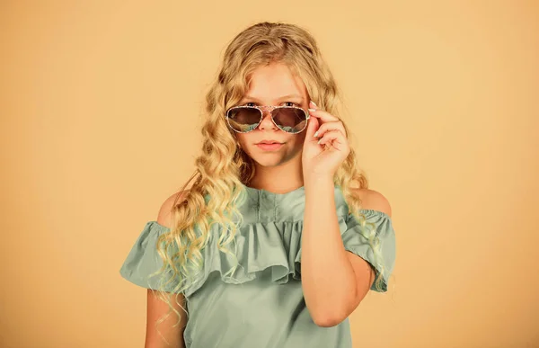 UV protection. Eye health. Buy proper sunglasses. Optics store. Cute small kid fashion girl. Girl long curly hair wear sunglasses. Sunglasses summer accessory. Summer trend. Little fashionista