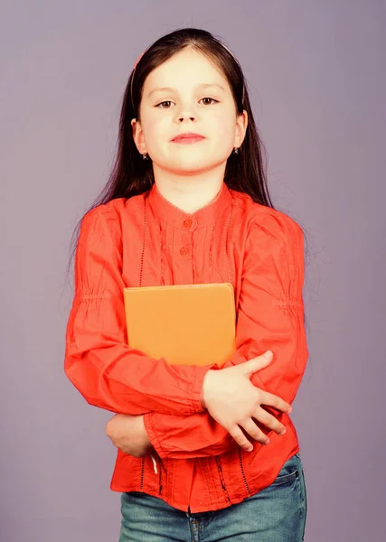 Poetry author. Girl hold book violet background. Kid show book. Book concept. Literature club. Development and education. Reading skill. Personal diary. Textbook presentation. Study and learn — Stock Photo, Image