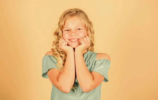Be positive and keep smiling. Small child long hair cheerful smiling face. Little girl happy smiling. Adorable beauty model with cute smile. Happiness concept. Happy childhood. Positive emotions
