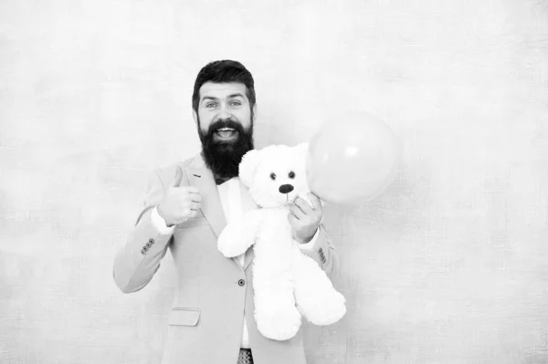 Macho ready romantic date. Man wear tuxedo bow tie. Womens day. Greetings 8 march. Stereotypical gifts. Valentines day. Romantic man with teddy bear and air balloon waiting girlfriend. Romantic gift — Stock Photo, Image