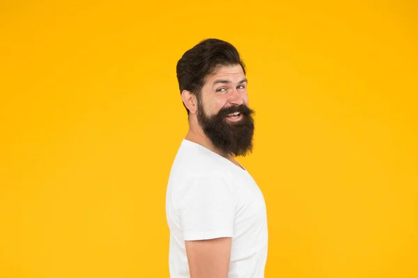 Cool and sexy. handsome confident man has perfect hairstyle. male facial care. portrait of brutal bearded man. thinking stylish man smiling. happy brutal bearded man on yellow background — Stock Photo, Image