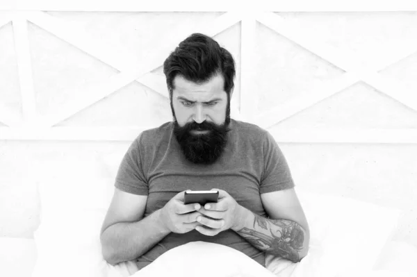 SMS communication. Bearded man use mobile phone in bed. Mobile communication. Cellular communication. Communication technology. Modern life — Stock Photo, Image