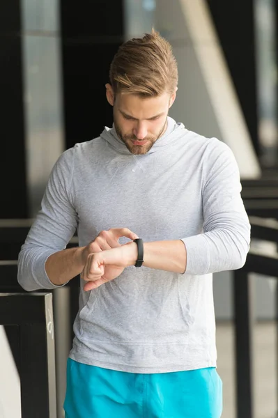 Best score. Monitoring concept. Check heart rate. Athletic man check smart watch. Handsome athlete use digital watch. Fitness tracking. Track distance and steps. Workout watch tracker. Sport gadgets