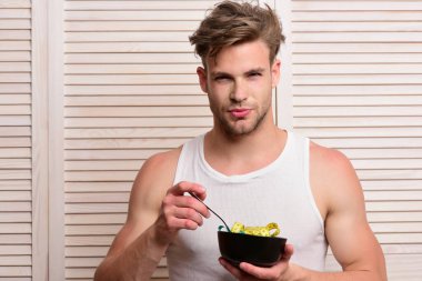 Spor, diyet ve beslenme konsepti. Adam erişte yiyormuş gibi yapıyor.