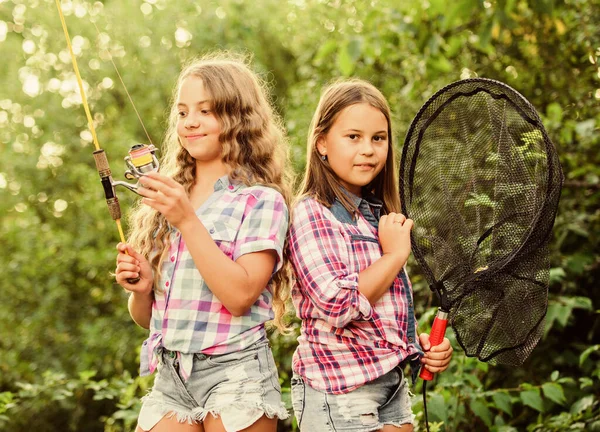 Fishing skills. Summer hobby. Happy smiling children with net and rod. Happy childhood. Adorable girls nature background. Teamwork. Camping activities. Fly fishing. Kids spend time together fishing — 스톡 사진
