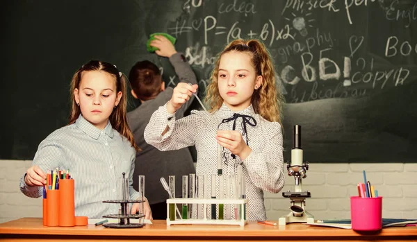 Future technology and science concept. Children study biology or chemistry school. School education. School girls study. Kids in classroom with microscope and test tubes. Explore biological molecules
