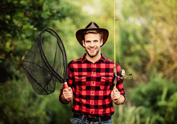 Gone Fishing. fisherman with fishing rod. happy man in cowboy hat. western portrait. Vintage style man. Wild West retro cowboy. fly fishing. man checkered shirt on ranch. fisher hold fish net. hobby — Stock Photo, Image