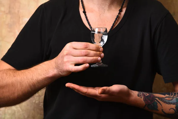 Alcoholic drinks spirits. Male hands hold alcoholic beverage