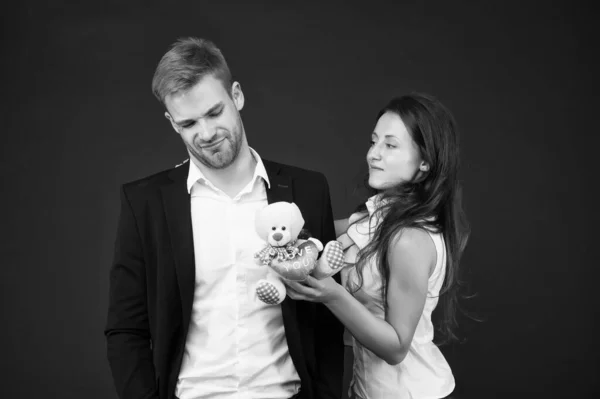 O par no amor celebra o dia dos namorados. Surpresa. Iniciativa inaceitável. Amor e romance. Presente com amor. Um casal num encontro romântico. Casal formal com brinquedo. Homem e mulher moda traje corporativo — Fotografia de Stock