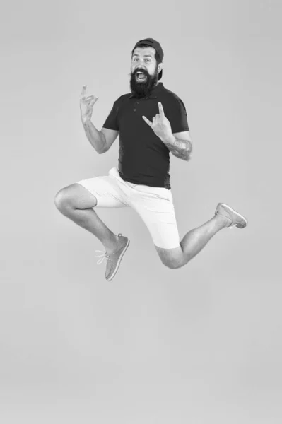 Energy charge. Healthy guy feeling good. Inspired concept. Always in motion. Enjoying active lifestyle. Happy guy jumping. Active bearded man in motion yellow background. Active and energetic hipster — Stock Photo, Image