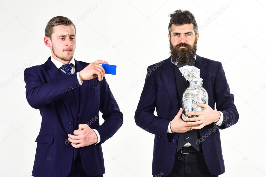 Men in suit, businessmen with jar full of cash