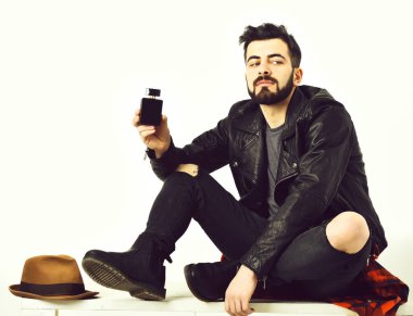 Sakallı bir adam, elinde parfüm şişesi olan beyaz bir hippi.