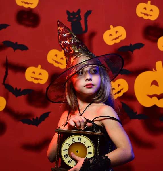 Een kleine heks met een zwarte hoed. Kind in griezelige heksen kostuum — Stockfoto