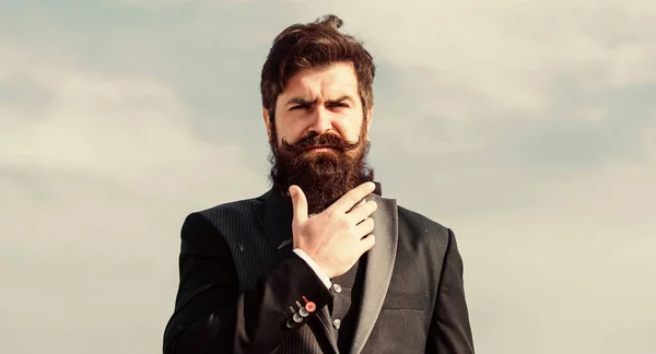 Vintage style long beard. Facial hair beard and mustache care. Beard fashion trend. Invest in stylish appearance. Grow thick beard fast. Man bearded hipster wear formal suit blue sky background