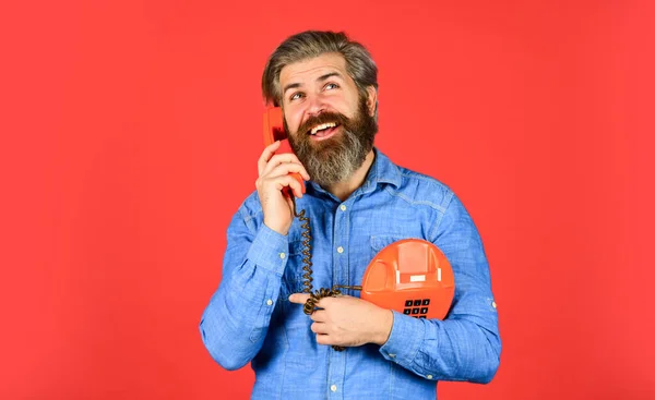Give your brand the due attention. young man talking on telephone. senior hipster old telephone. brutal guy with telephone. mature bearded man talk on retro phone. vintage technology in modern life