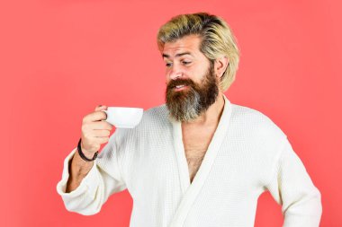 Sabah titreşimleri. Yorgun adam kahve içiyor. Her sabah kahveyle başlar. Bornozlu bekar. Sabahlık giymiş sakallı bir adam. Banyo elbiseli adam kahve tutuyor. Sabah ritüelleri konsepti