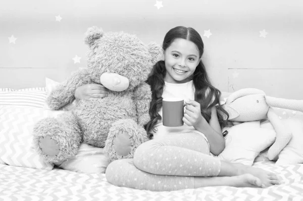 Drinking milk just before bed. Bedtime beverage. Hot milk before sleep. Health Benefits Drinking water before bed. Little child hold mug. Girl in pajamas drinking tea. Relaxation before sleep