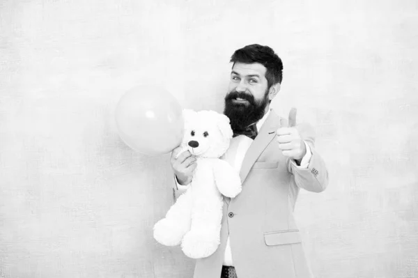 Valentines day. Romantic man with teddy bear and air balloon waiting girlfriend. Romantic gift. Macho ready romantic date. Man wear tuxedo bow tie. Womens day. Greetings 8 march. Stereotypical gifts — Stock Photo, Image