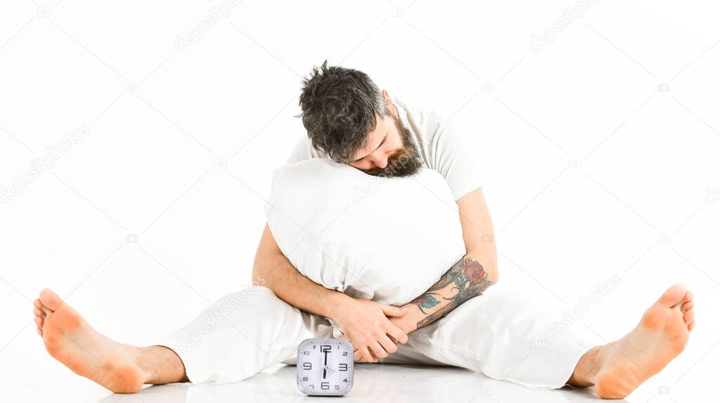 Man with tattoo fall asleep while sitting, white background.