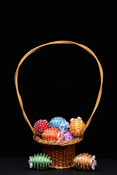 Eggs decorated with bright color threads and beads in pottle — Stock Photo, Image
