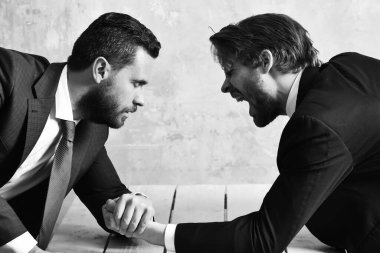 Kaybeden adam bağırıyor, bilek güreşi yeniliyor ve iş adamının zaferi.