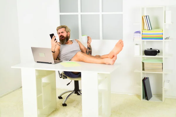 Lockdown self isolation and quarantine. Barefoot guy working from home. Man work laptop. Too lazy to work. Comfortable workplace. Social networks. Social distancing. Always wanted to work from home — Stock Photo, Image