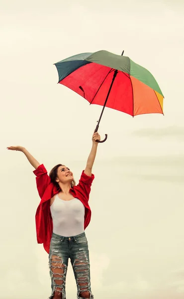Good mood at any weather. autumn weather forecast. carefree time spending. autumn fashion. Rainbow umbrella protection. rainy weather. Fall positive mood. pretty woman with colorful umbrella