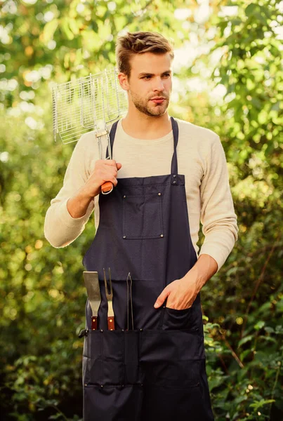 Enjoying nice weekend. picnic cooking utensils. Outdoor party weekend. Family weekend outing. Summer picnic. Tools for roasting meat outdoors. man barbecue grill. Culinary. Chef cooking bbq food