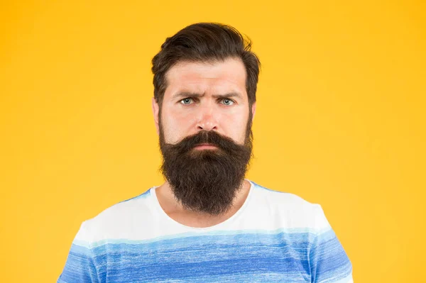 Bend his brows. serious stylish man with moustache. thinking brutal bearded man on yellow background. handsome confident man has perfect hairstyle. male facial care. portrait of brutal bearded man — Stock Photo, Image