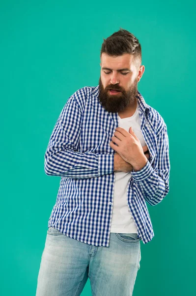 Symptoms of myocardial infarction. Heartache and chest pain. Healthcare. Preventing heart disease. Oh my heart. Bearded man suffer from heart pain. Hipster hold hand on heart. Cardiovascular health