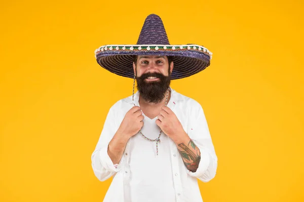 Explore heritage on your paternal line. Gain insight into ancestral origins. Mexican origins tradition. Ethnic origins. Customs and culture. Guy cheerful festive mood at party. Man in mexican hat — Stock Photo, Image