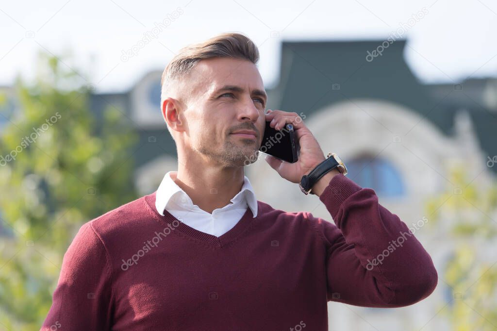 Listening. Call partner. Mobile negotiations. Business communication. Online communication. Modern communication. Businessman hold mobile phone. Handsome man with phone outdoors. Mobile lifestyle